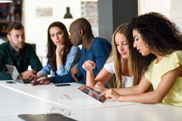 multi-ethnic-group-of-young-people-studying-with-laptop-computer_1139-993